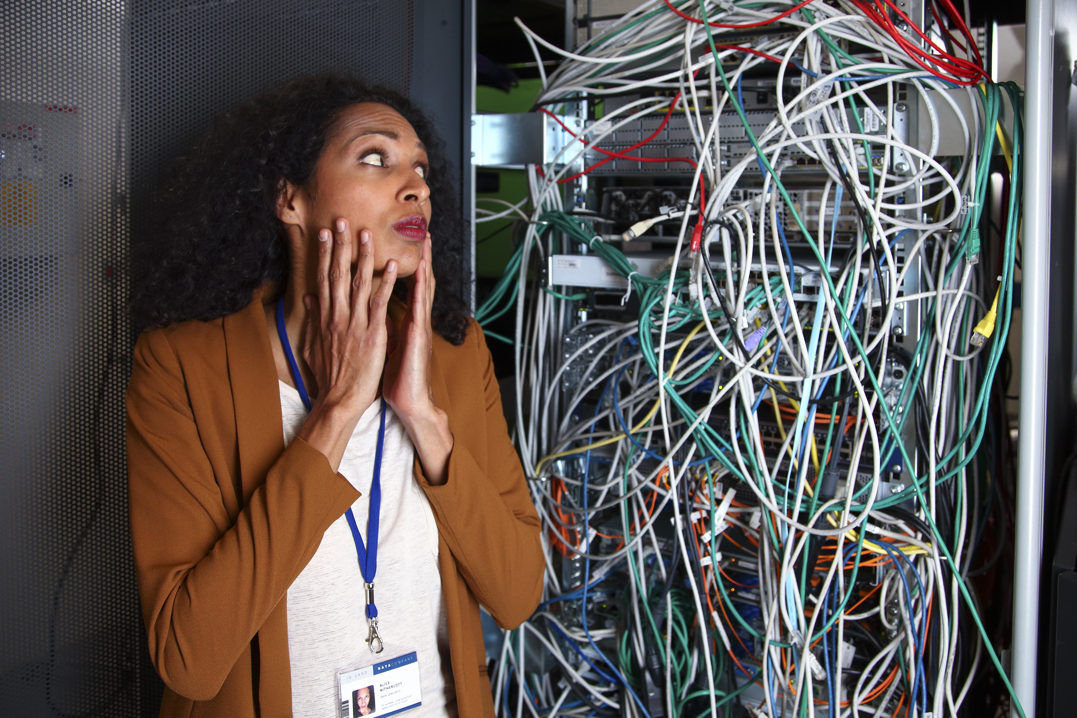 female engineer in computer center full of wires